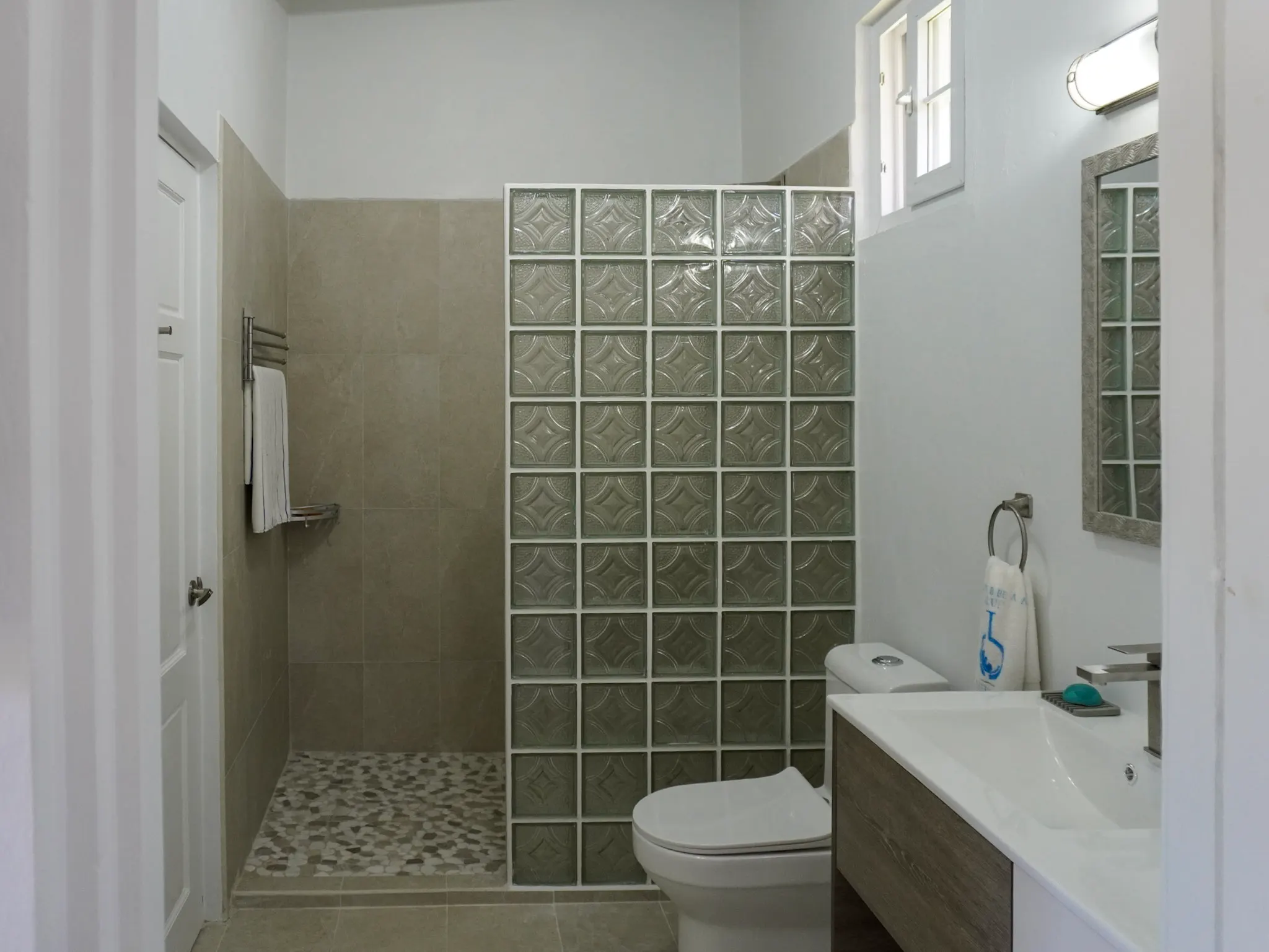 Walk-in bathroom shower stocked with natural toiletries