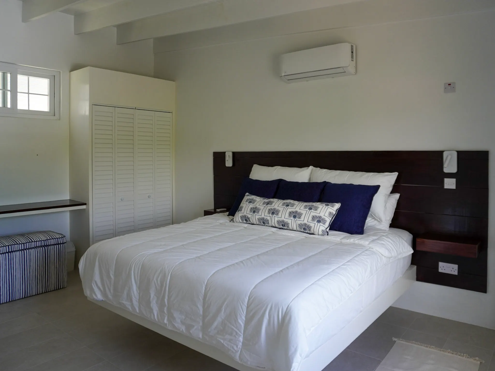 King bedroom with navy accent pillows
