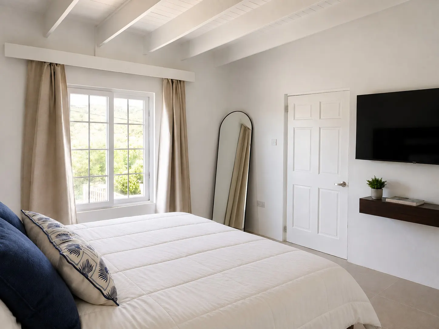 Bedroom window with curtains, full-length mirror and wall-mounted TV