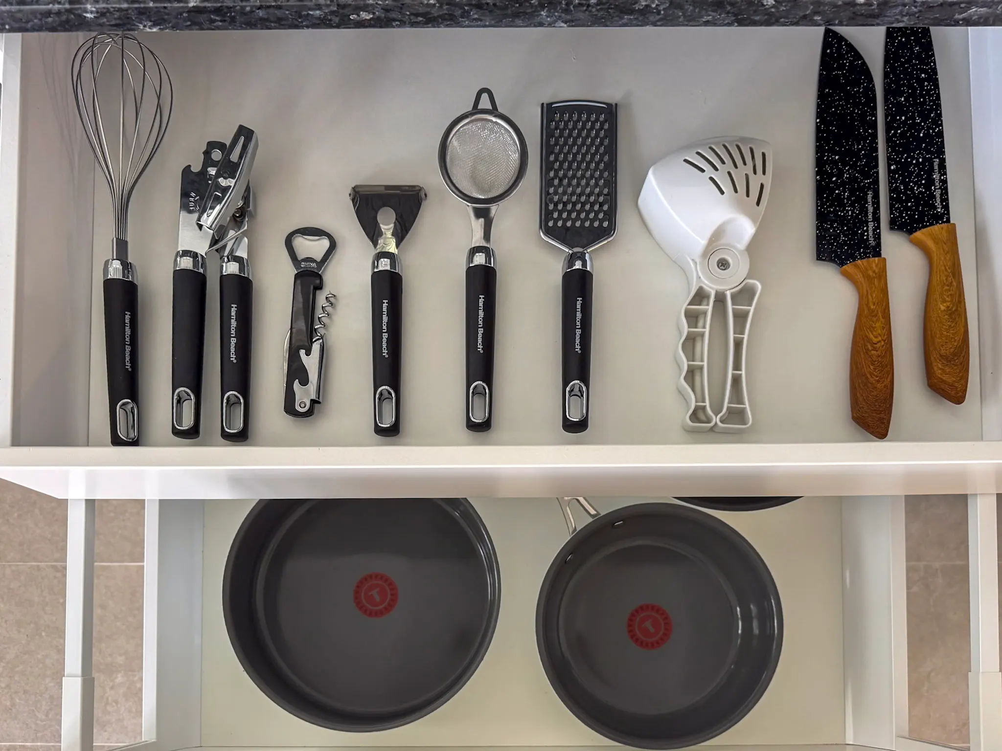 Stocked kitchen counter with fresh fruit and cookware